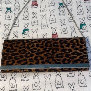 Call It Spring Leopard print clutch bag.